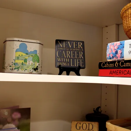 a shelf with pictures and art on it