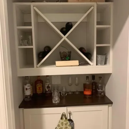 a white cabinet with glassware