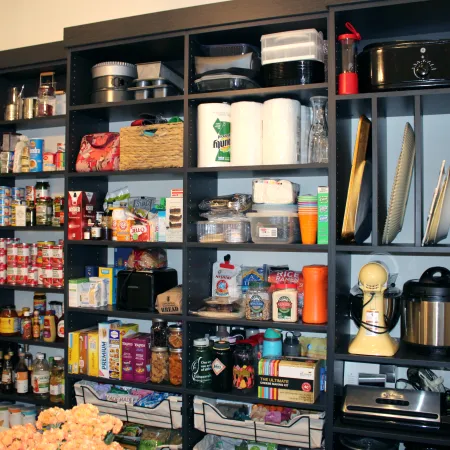 a kitchen with shelves full of food