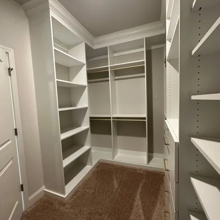 a room with shelves and a rug