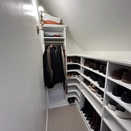 a closet with clothes and shoes