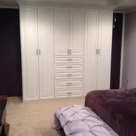 a bedroom with a bed and a closet