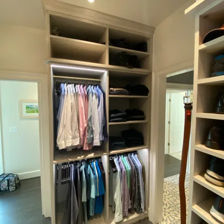 a closet with clothes and a door