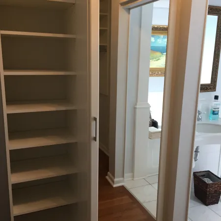 a room with a door and shelves