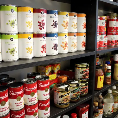 a shelf with many bottles of liquid on it