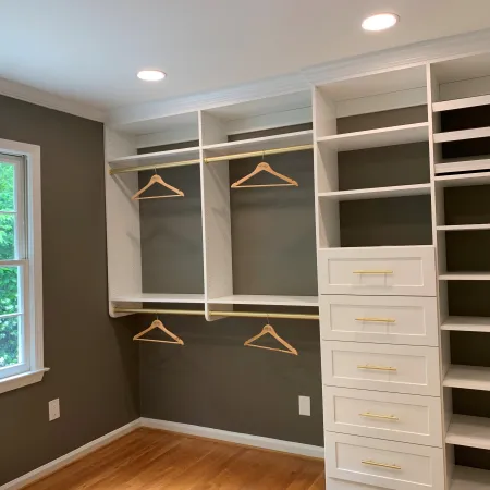 a room with white cabinets and a window