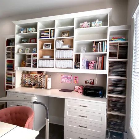 a white shelving unit with books