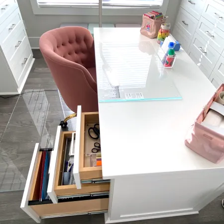 a desk with a chair and a computer on it