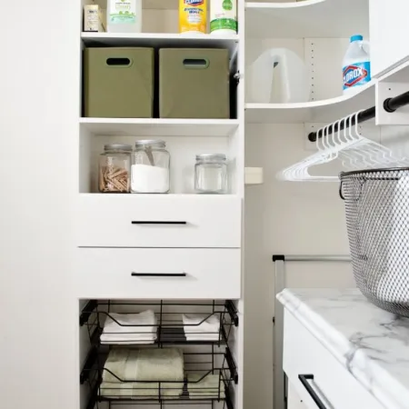 a white shelving unit with many objects on it