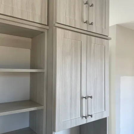 a white cabinet with a door