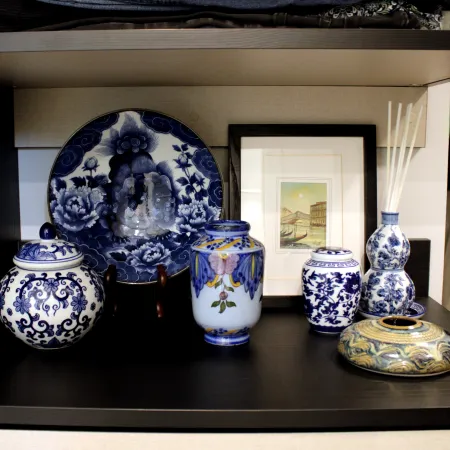 a shelf with vases and bowls