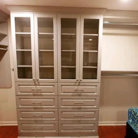 a white cabinet with glass doors