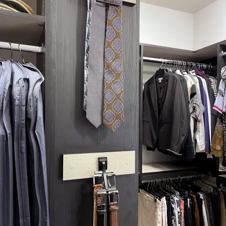 a closet with a tie and a coat rack