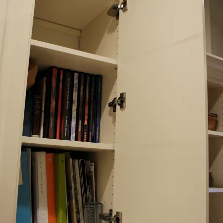 a white bookcase with books