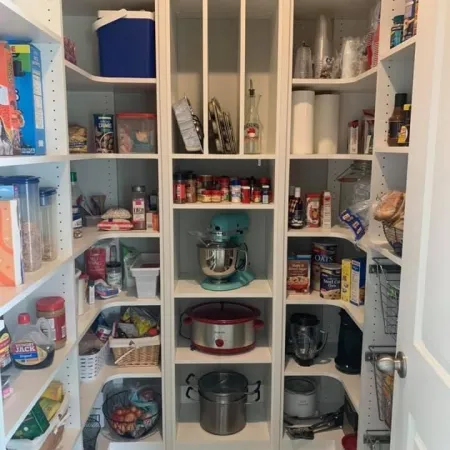 a white shelving unit with many items on it