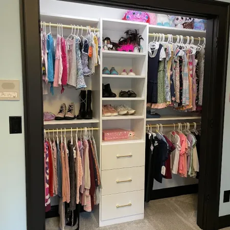 a closet with clothes and shoes