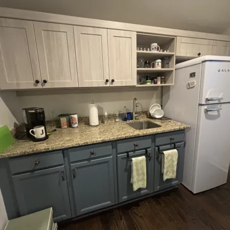 a kitchen with a refrigerator and cabinets