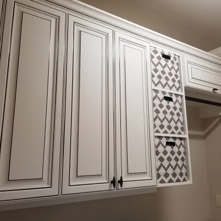 a white cabinet with a black and white design on it