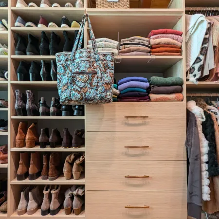 a closet with clothes and shoes