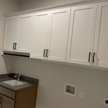 a white kitchen with white cabinets