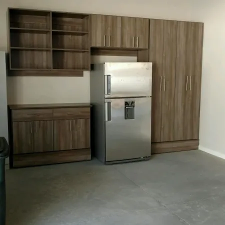 a kitchen with a refrigerator and cabinets