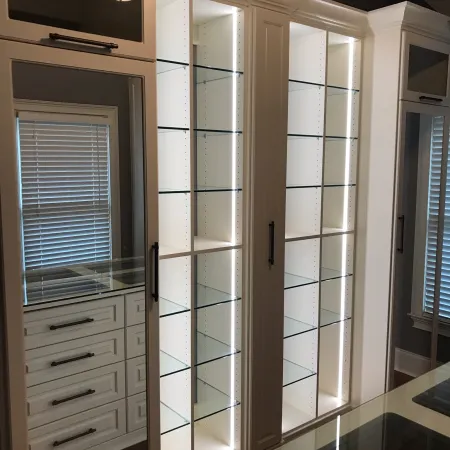 a white cabinet with glass doors