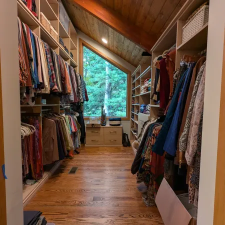 a room with a wood floor and a wood ceiling with a window