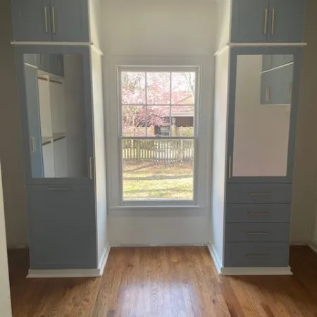 a room with white cabinets and a wood floor