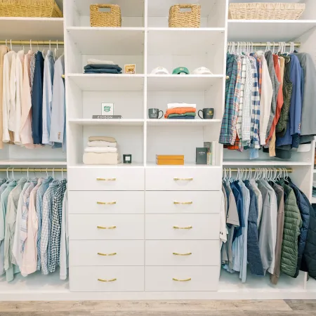 a closet with clothes and shelves