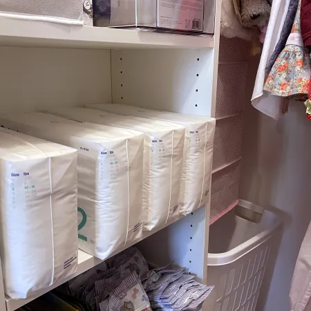 a white shelf with a white towel and a white towel