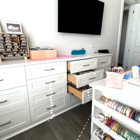 a room with white cabinets and a television on the wall