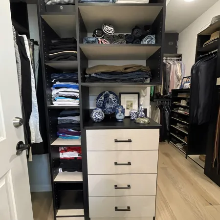 a closet with clothes and shoes