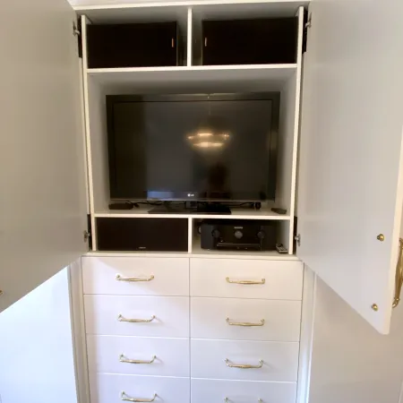 a white cabinet with a television on top