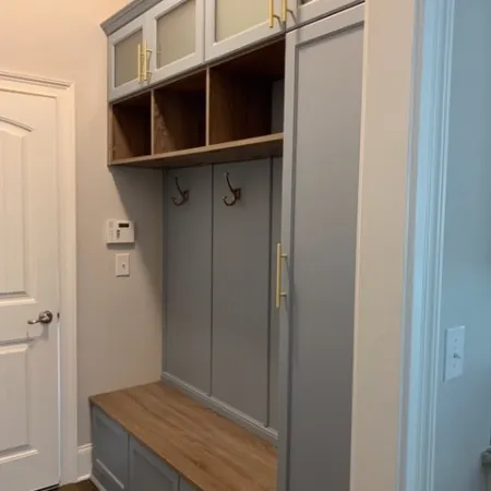 a cabinet with a door and a shelf with drawers