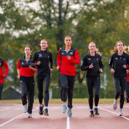 a group of people running on a track