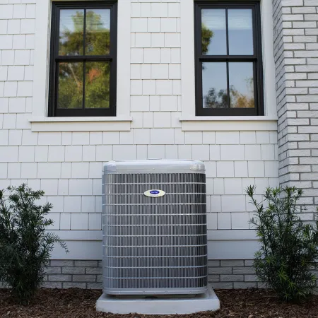 a white building with a metal box in front of it