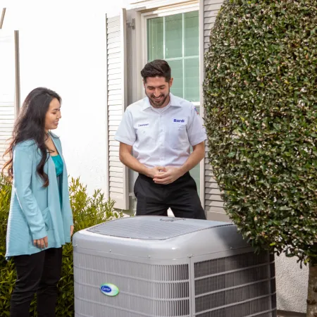 a man and a woman standing next to a radiator