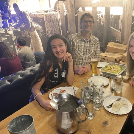 a group of people sitting at a table with food