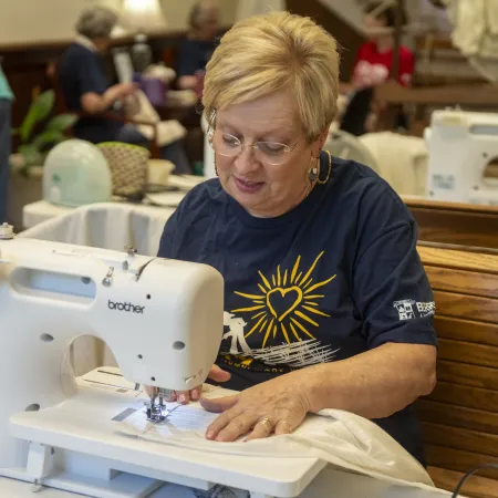 a person working on a sewing machine