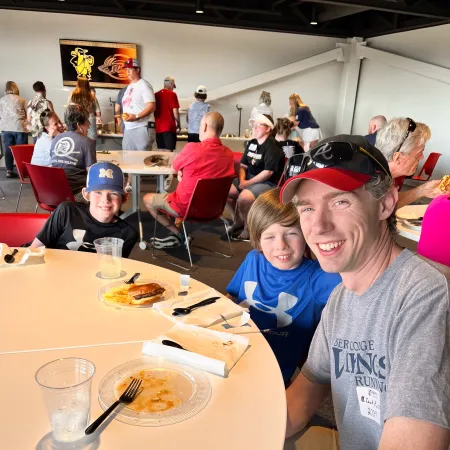 a group of people sitting at a table with food