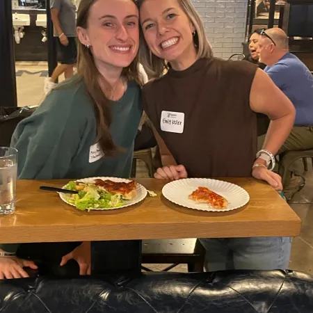 a couple of girls holding a plate of food