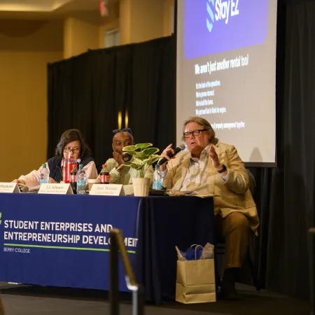 Student panel discussion at Berry College entrepreneurship and student enterprise development event indoors.