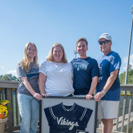 a group of people posing for a photo on a deck