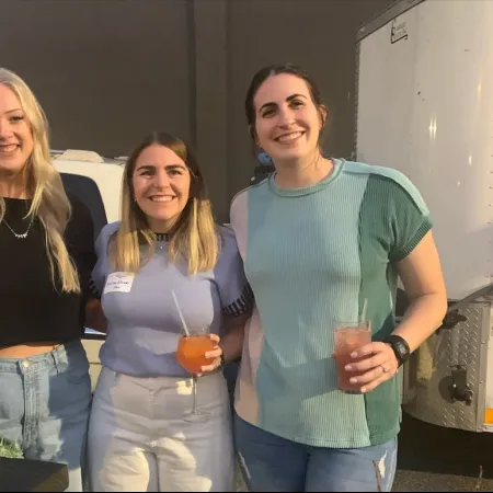 a group of women holding drinks