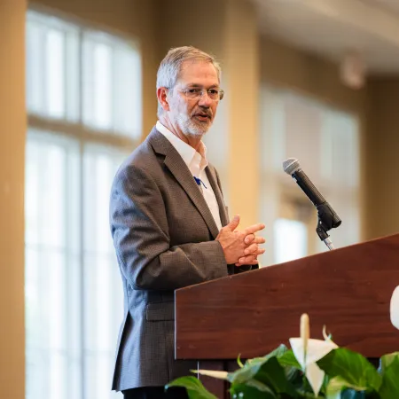 a man standing at a podium