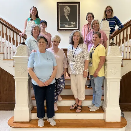 a group of people posing on the stairs