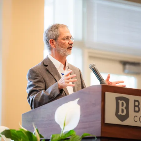 a man speaking at a podium