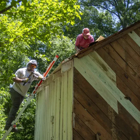 men constructing a house