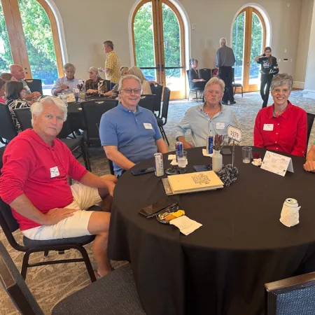 a group of people sitting around a table