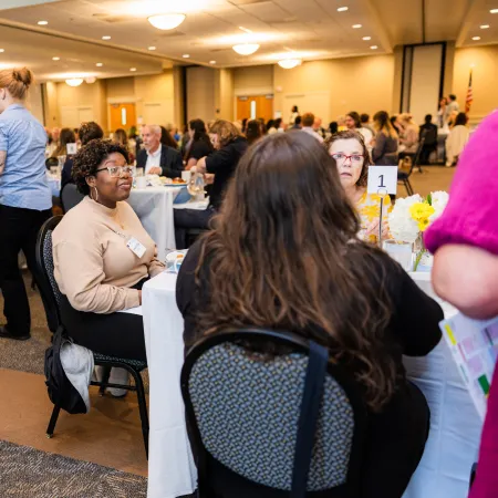 a group of people sitting at tables